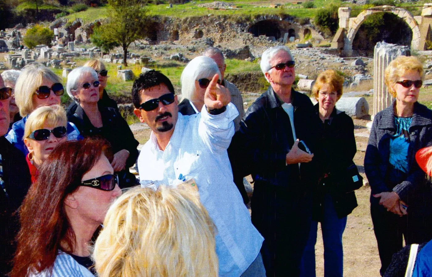 Guide explaining a site while a group listens